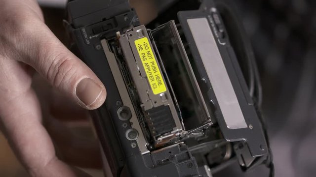 Inserting mini DV cassette tape into the camcorder