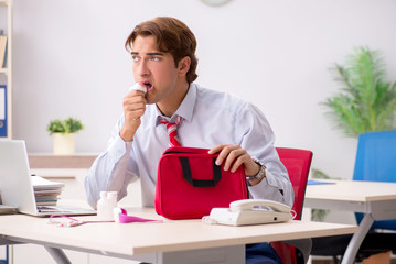 Man with first aid kit in the office