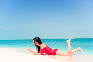 Young woman on a tropical beach with hat