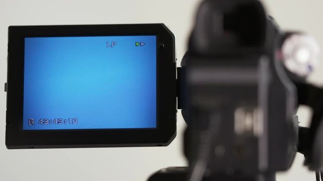 Indicators on LCD screen of digital camcorder while rewinding mini DV cassette tape