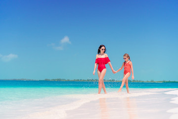 Fototapeta na wymiar Beautiful mother and daughter on Caribbean beach