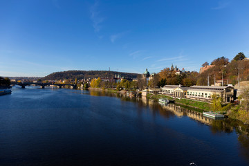 Colorful autumn Prague gothic Castle with the Lesser Town above River Vltava in the sunny Day, Czech Republic