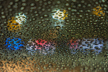 Raindrops on car glass at night