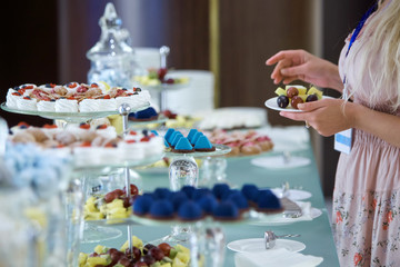 Women's hands taking sweets