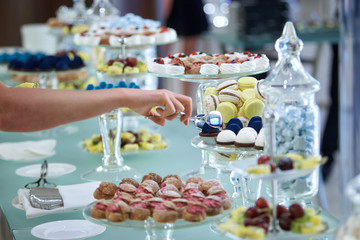 Women's hands taking sweets