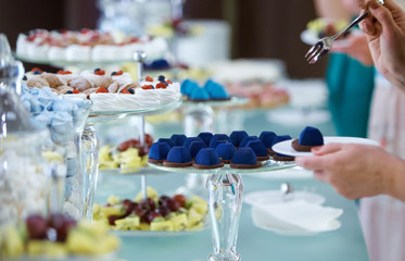 Women's hands taking sweets