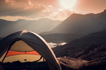 camping in the mountains at sunset.  Tent setup with an amazing view of the Sierra Mountains.