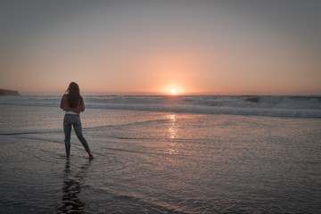 Fototapeta premium Women watching the beautiful sunset over the Pacific Ocean. Redondo Beach just outside Los Angeles. 