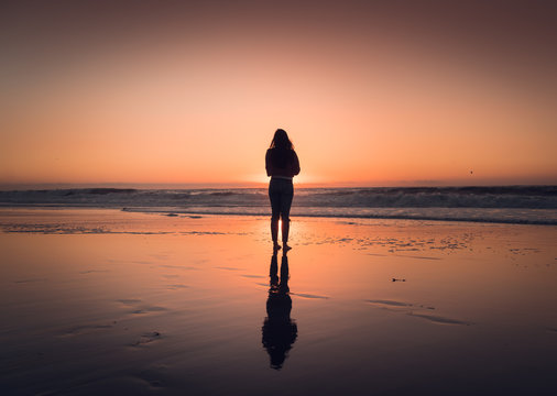 silhouette of woman at sunset in Redondo Beach California right outside of Los Angeles 