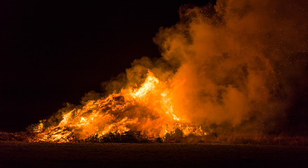 Fototapeta na wymiar Christmas trees burning intensively on a field at night