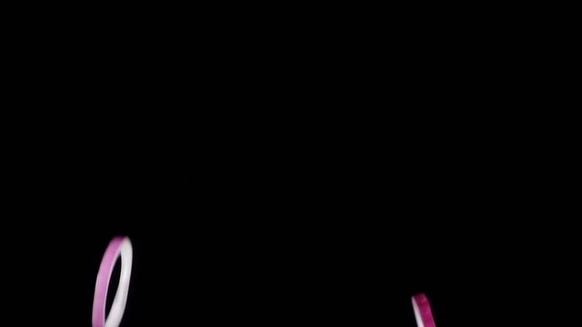 Falling rings of red onion slices, slow motion