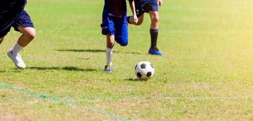 Soccer players run to trap and control the ball for shoot to goal