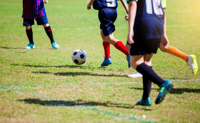 Soccer players run to trap and control the ball for shoot to goal
