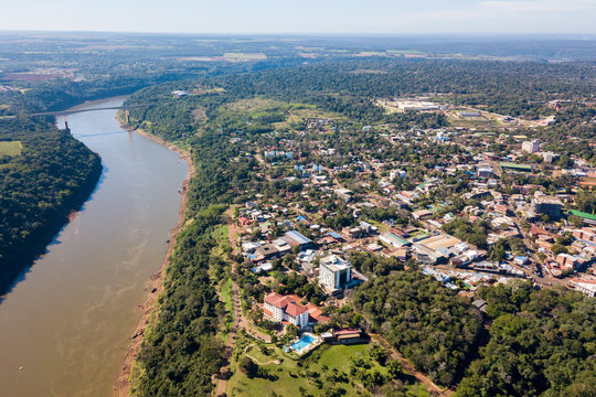 Town of Puerto Iguazu city centre aerial view. Tancredo Neves Bridge (Fraternity Bridge) border crossing Brazil—Argentina over the Iguassu River.
