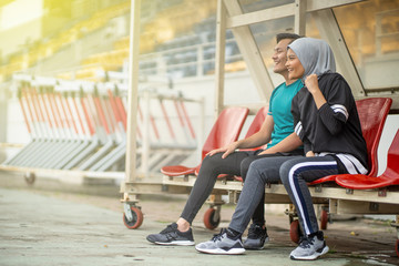 Fototapeta na wymiar Asian couple at track stadium exercising for healthy lifestyle