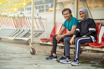 Fototapeta na wymiar Asian couple at track stadium exercising for healthy lifestyle