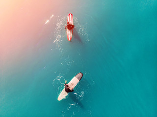 Surfer top of wave in ocean, top view aeria