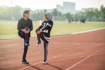 Asian couple at track stadium exercising for healthy lifestyle