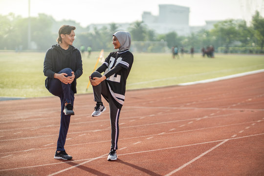 Asian couple at track stadium exercising for healthy lifestyle