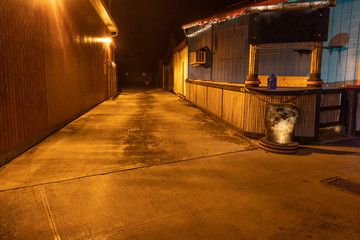 Yellow light illuminating an empty alley at night, Kapa'a, Kaua'i, Hawai'i