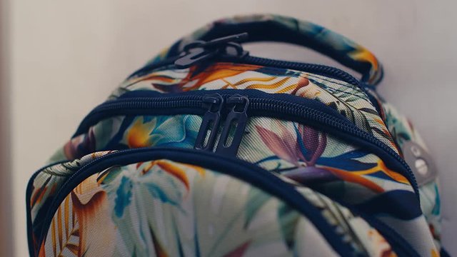 Close up of child pupil hands packing backpack and preparing for junior high school, 4k