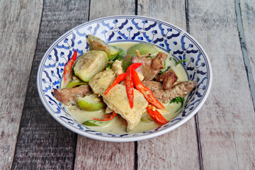 Green chicken curry in coconut milk with eggplant .