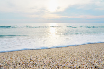 Fototapeta na wymiar Waves with foam hitting sand on the tropical beach texture.