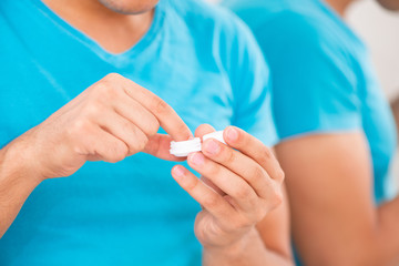 Man trying contact lenses at home