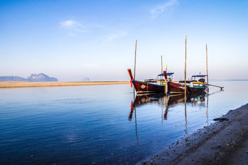 Long tail boats moored in river estuary