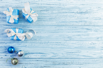 Christmas presents packed with ribbons on wooden background