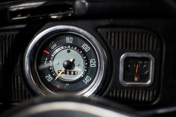 Old car dashboard and instrument claster on dark interior	