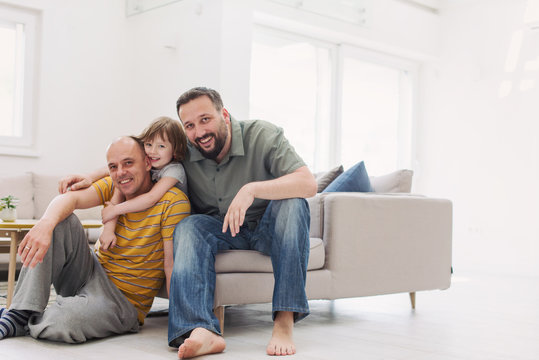 Portrait Of Male Gay Couple With Adopted Childre