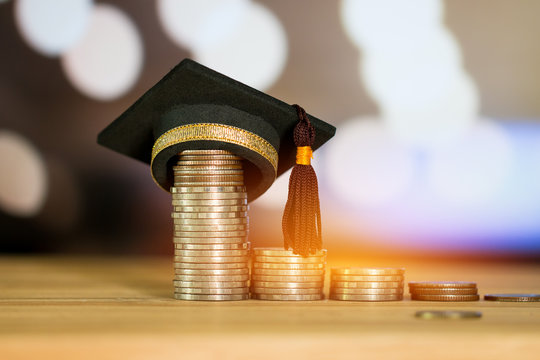 Education Graduate study scholaship concept : Congratulations graduates on top stacks of coins on wood table color background. Ideas Educational for successs study or business have to use many Money