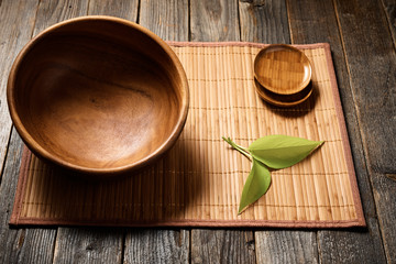 Empty wooden bowl on natural background