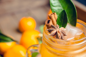 Icy cold mandarin beverage on the rustic background. Selective focus. Shallow depth of field.