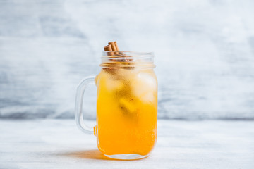 Icy cold mandarin beverage on the rustic background. Selective focus. Shallow depth of field.