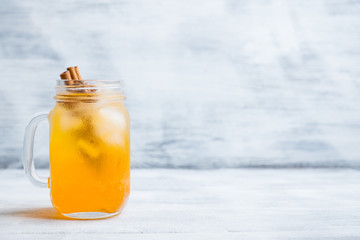 Icy cold mandarin beverage on the rustic background. Selective focus. Shallow depth of field.