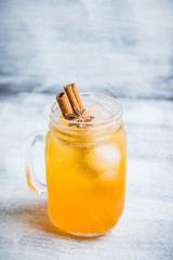 Icy cold mandarin beverage on the rustic background. Selective focus. Shallow depth of field.