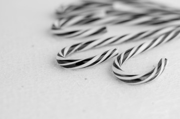 Black and white  stripes candy canes on a wooden background