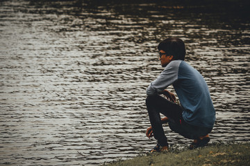 Man sitting besides the lake