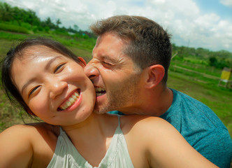 young beautiful and happy mixed ethnicity couple beautiful Asian Chinese woman and white man in...