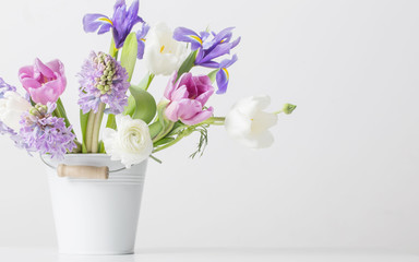 spring flowers in bucket on white  background
