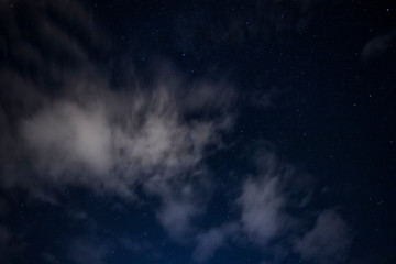 Obraz na płótnie Canvas light cloud coverage over starry night covering starry night 