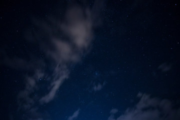 Obraz na płótnie Canvas light cloud coverage over starry night covering starry night 