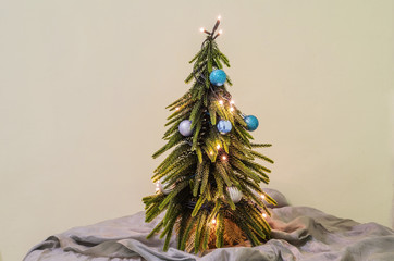 Christmas tree. Blue ornaments and yellow lights. Cozy and inviting atmosphere	