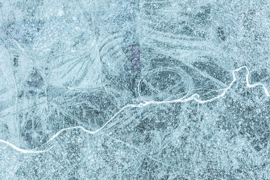 Cracked ice river surface macro view. Natural cold crystal ice winter texture background