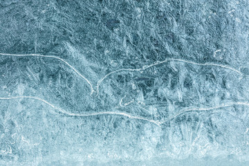 Crystal ice block surface with cracks macro view. Natural winter texture background