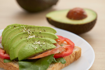 Sandwich with avocado slices and bacon