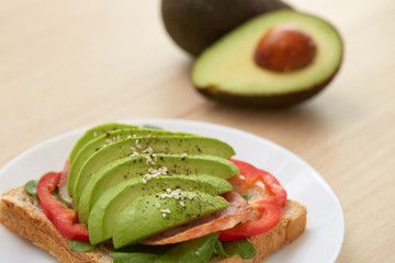 Sandwich with avocado slices and bacon