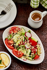 Detox salad.Vitamin salad with tomato, cucumber, radish and raw organic green buckwheat sprouts